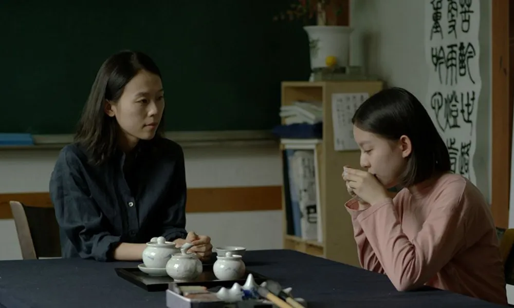 Two Asian women speaking. 