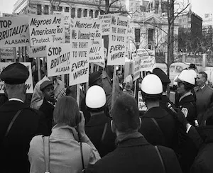 Protestors walking around with signs in DC. 