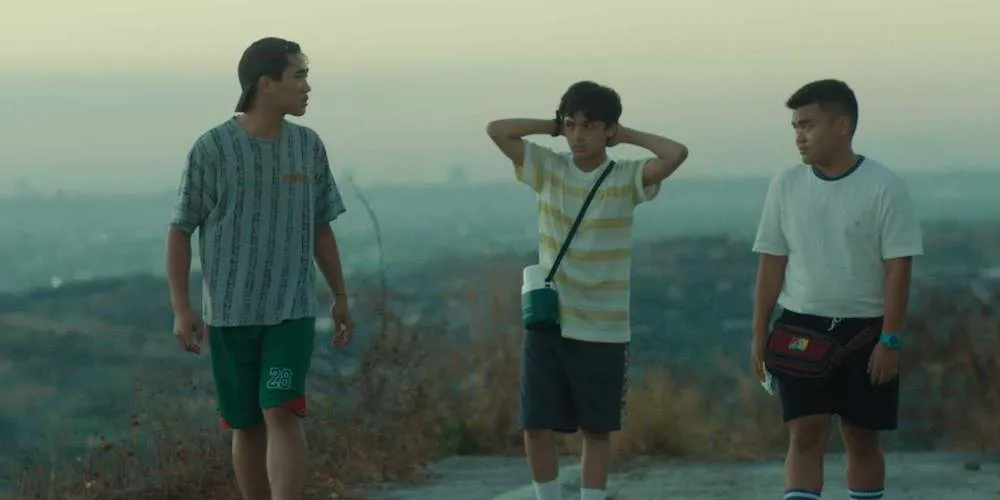 Young Asian men standing on a hill 
