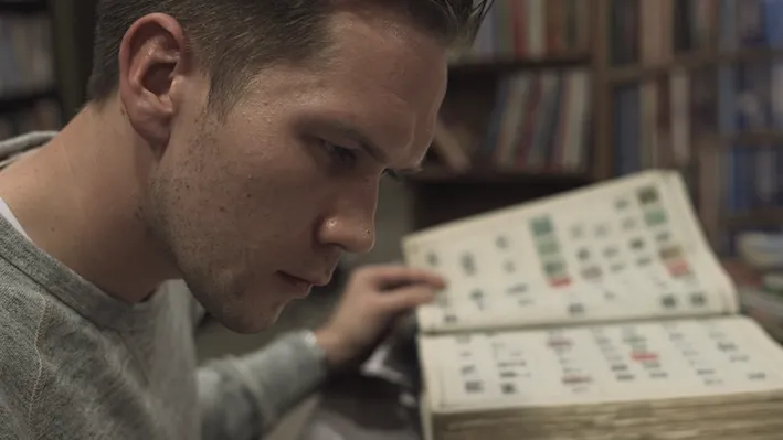 A white man reading a book.