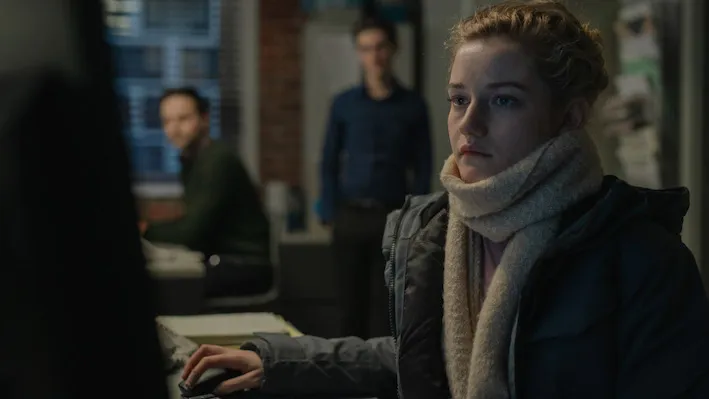 A blond woman staring in the distance.
