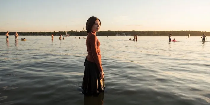 Orthodox woman standing in the water