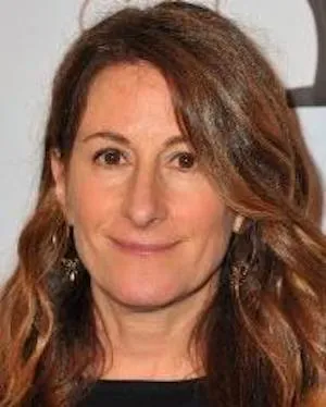 White woman with brown hair, parted, smiling