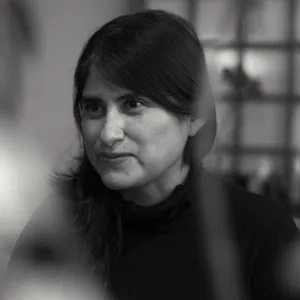 Black and white photo of a brunette woman smiling.