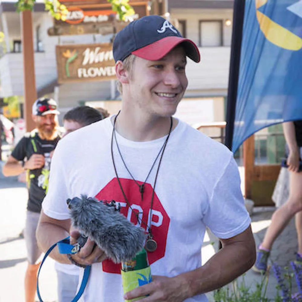 White boy with a baseball hat smiling 