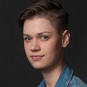 Portrait of a person with short hair. 