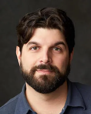 Photo of a light-skinned man with facial hair.