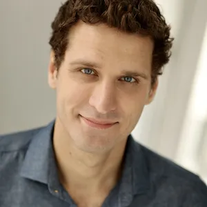 Portrait of a white man with curly hair