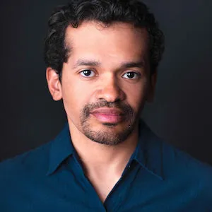 Man with facial hair and a blue button up shirt