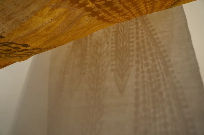 04-07 - Traveler (Shadow Embroidery) installation view, 2015, Shadow projections from paper collage mounted on handloom silk textile, by Alyssa Pheobus Mumtaz ’08