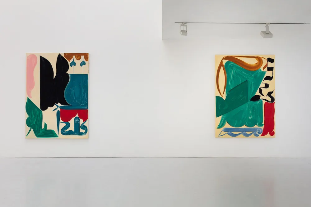 two pieces of colorful artwork on the wall