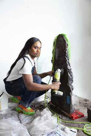 A photo of the artist with work