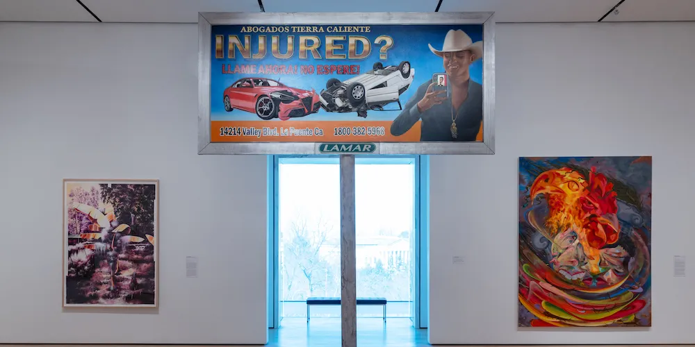Artworks displayed on white gallery wall. 
