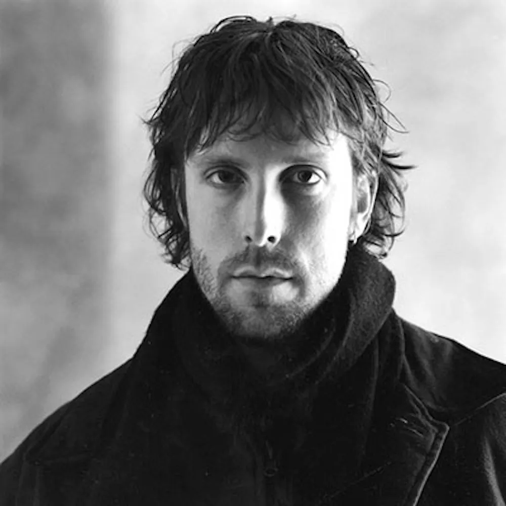 Black and white portrait of a white man with longer hair