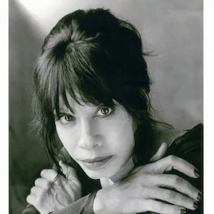 Black and white portrait of a woman with dark hair arms folded