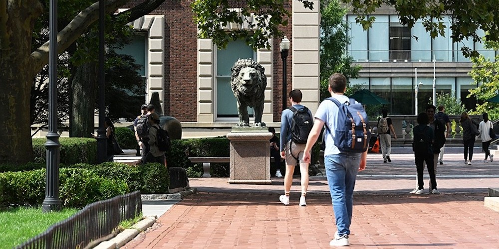 students walk outside on campus