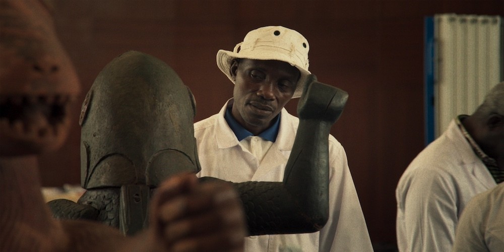 Courtesy of Mubi. A man looks at a statue