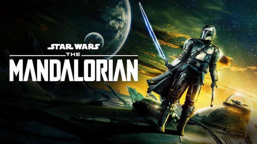 In space, a figure wearing an armored suit holds a light saber next to a child alien