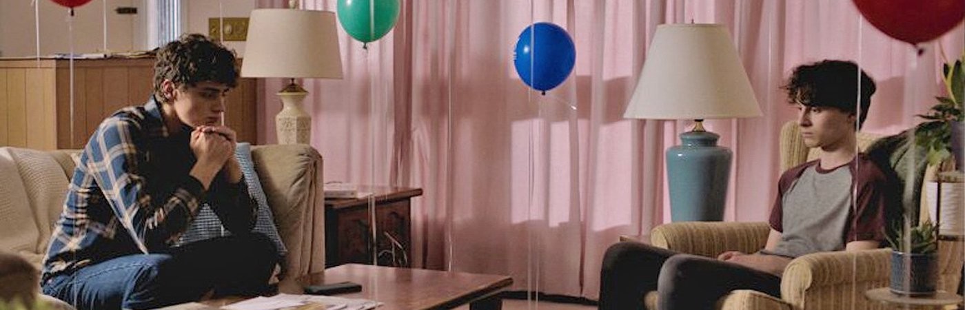 Young boys in a living room with balloons