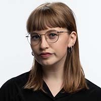 woman with light brown hair and glasses wearing black shirt