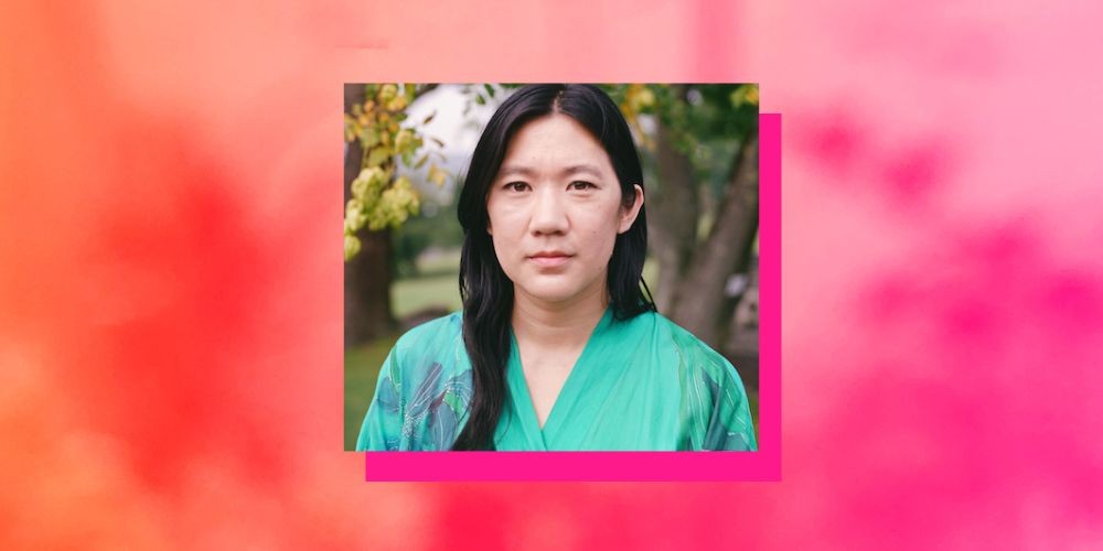 Headshot of Diana Khoi Nguyen on a pink background