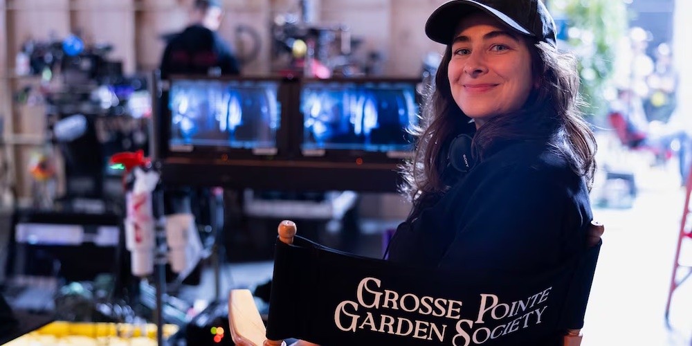 A woman sits in a director's chair labeled Grosse Pointe Garden Society