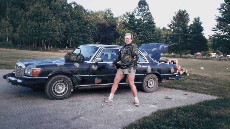 person posed with camouflage pattern car