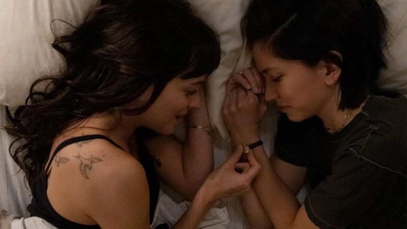 Still from 'AM I OK?' two women in bed facing each other