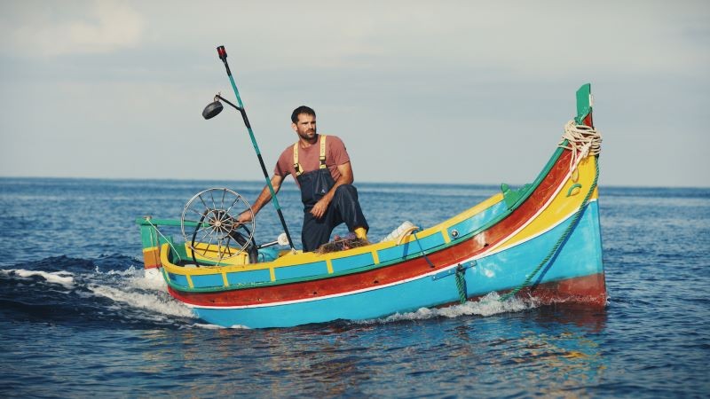 Man in colorful boat