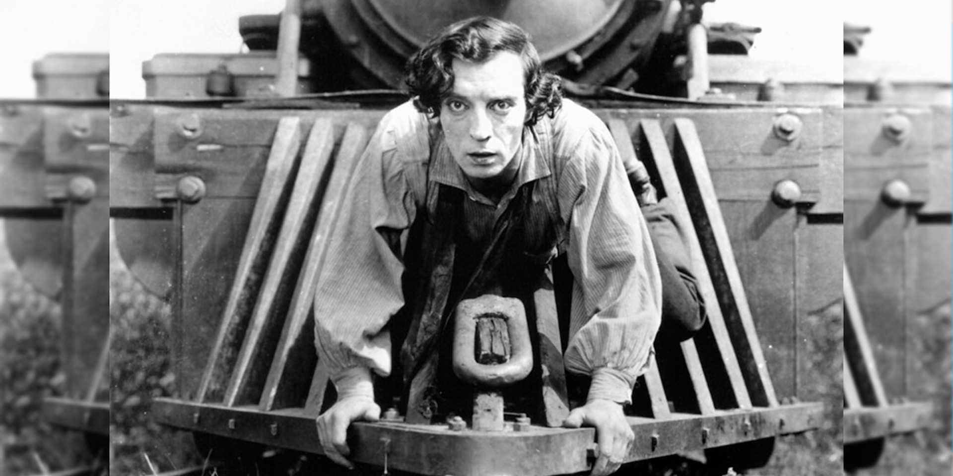 Still image from Buster Keaton image. Buster Keaton on top of a locomotive.