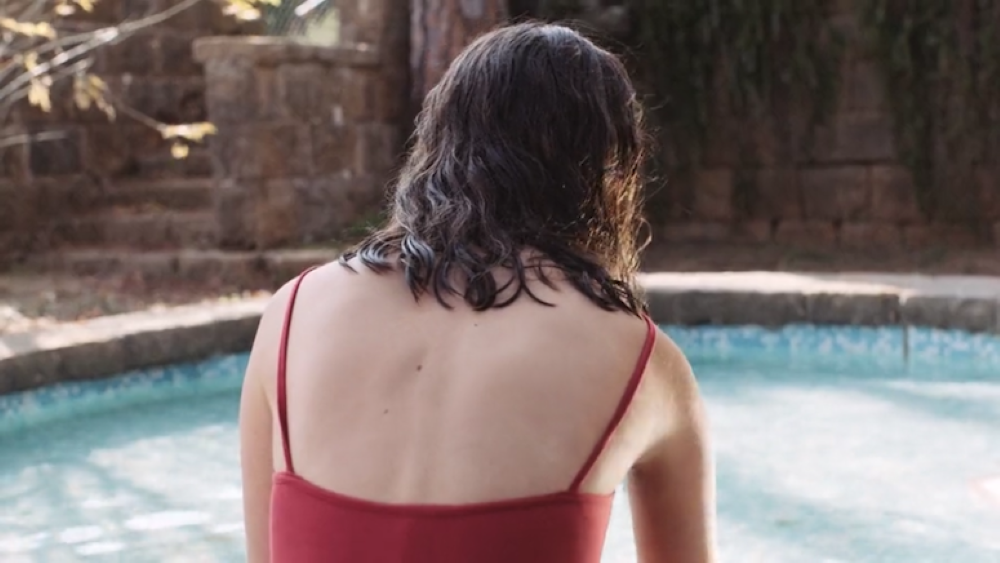 Woman in swimwear with back turned to camera