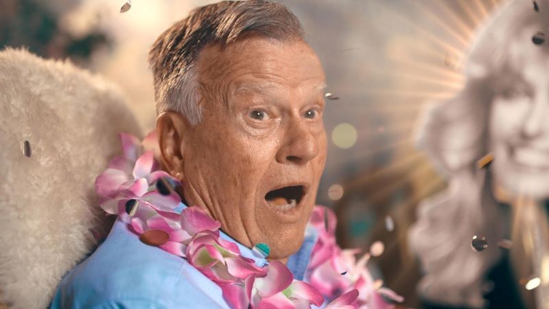 Man wearing leis with mouth agape 