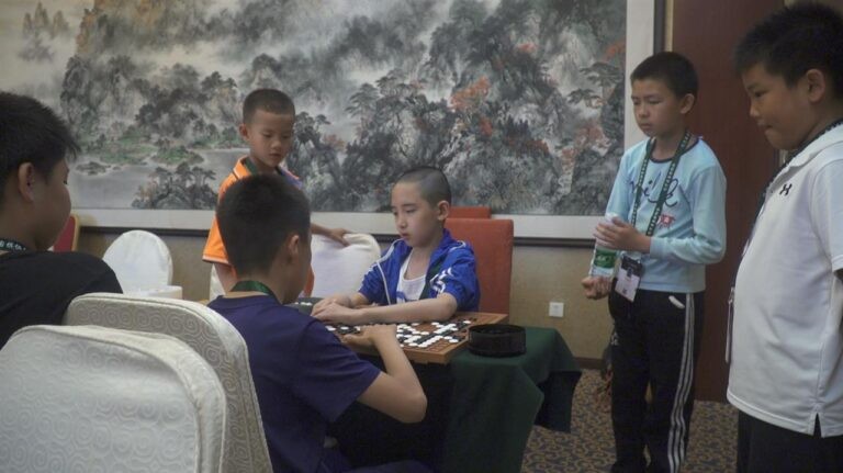 Children in a room playing Go