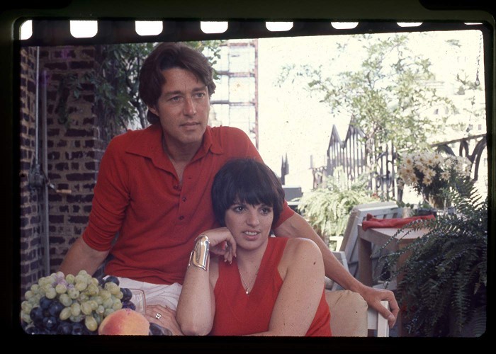 Still from Halston, Courtesy of IMDB A man and a woman sit together.