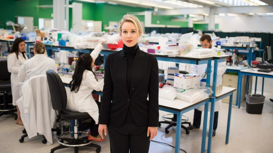 A woman stands in a lab.