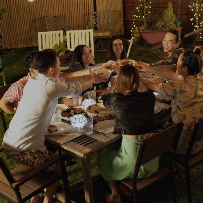 Group of people seated around an outdoor table
