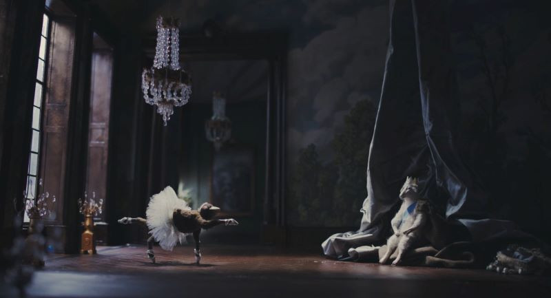 Still from 'Louis I., König der Schafe (Louis I., King of the Sheep)' surreal image of animal in tutu performing in large, ornate room