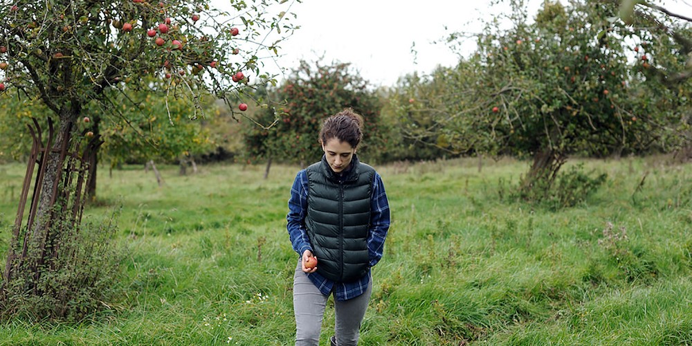 Woman walking in Apple orchard