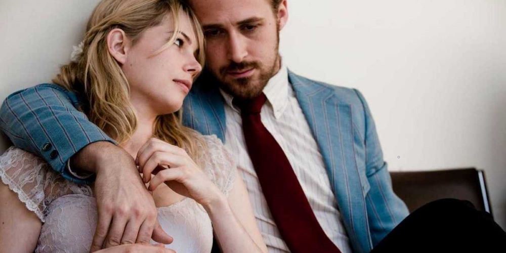 Still from 'Blue Valentine,' executive produced by Professor Jack Lechner man in blue suit with his arm over woman resting her head on his