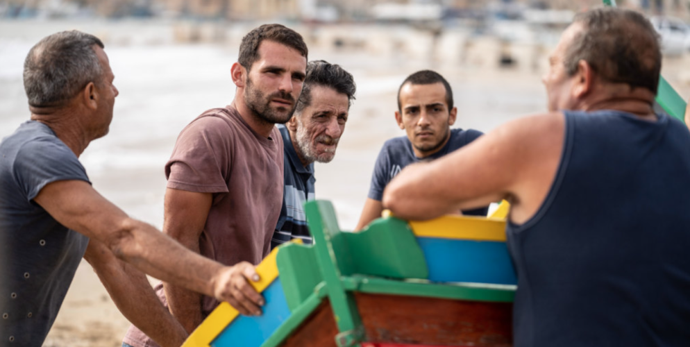 Still from 'Luzzu' group of men in short sleeve shirts
