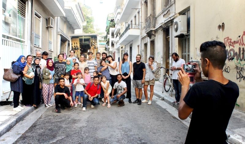 In Athens, behind the scenes of 'Refuge' Crowd of people posing for a picture