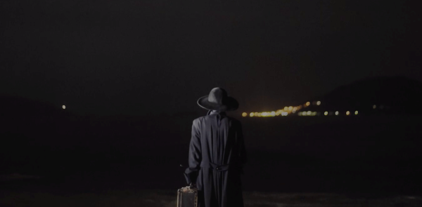 Kio Shijiki enjoyed filming in Japan so much, she plans to do more. There are more stories of her country to tell. Person in sunhat looking at a lighted bridge in the distance