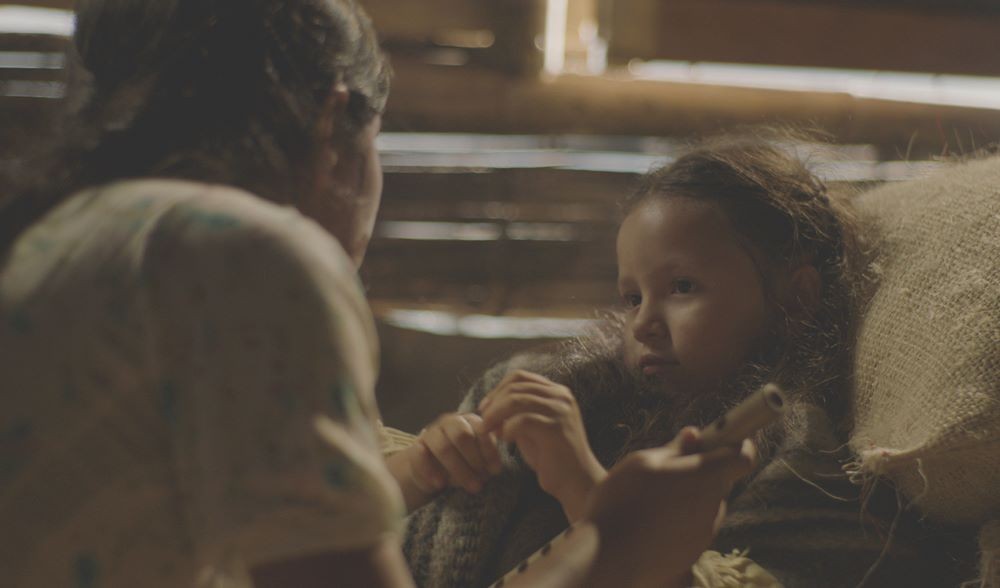 Older woman speaking to young child