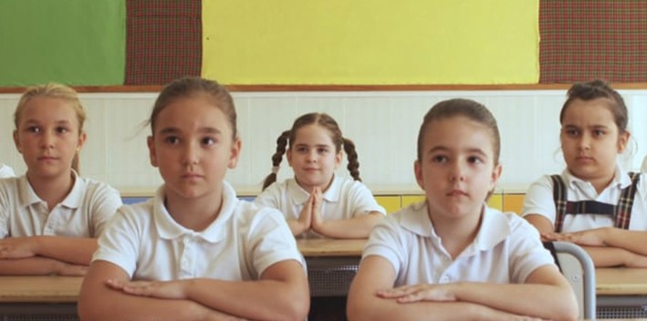 Still from 'Something to Believe In (Algo en lo que creer)' where a group of 5 schoolgirls look to the front.