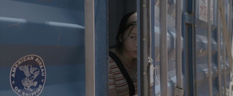 Person peeking through an industrial blue door