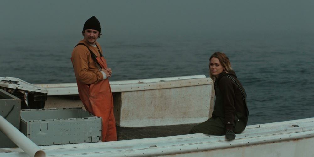 Man and woman in fishing apparel on a boat