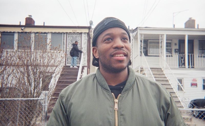 Man standing outside two houses