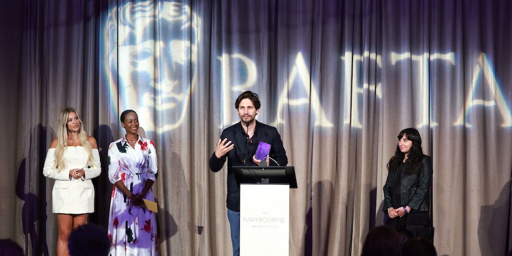 A man on stage accepting an award.