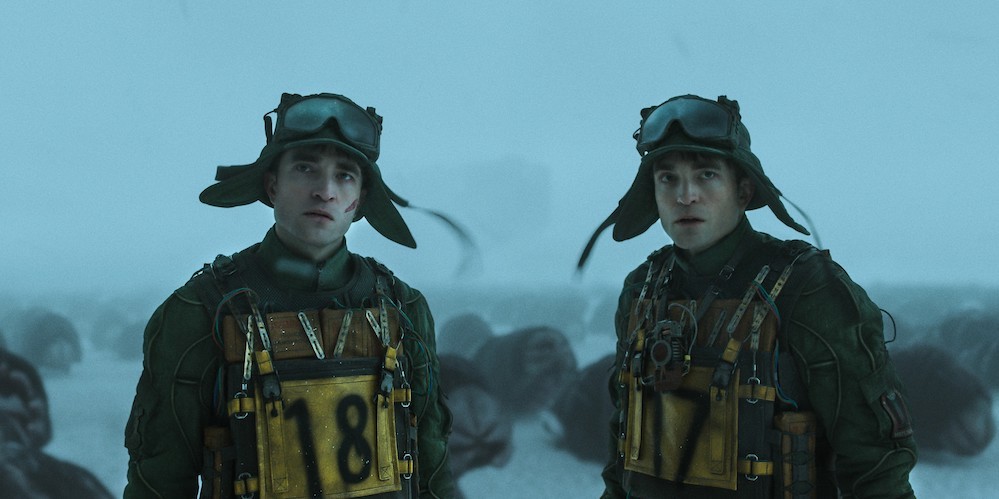 Two men stand in cold weather.