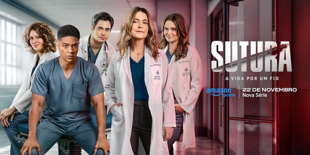 People in medical scrubs stand in a group looking at the viewer. 